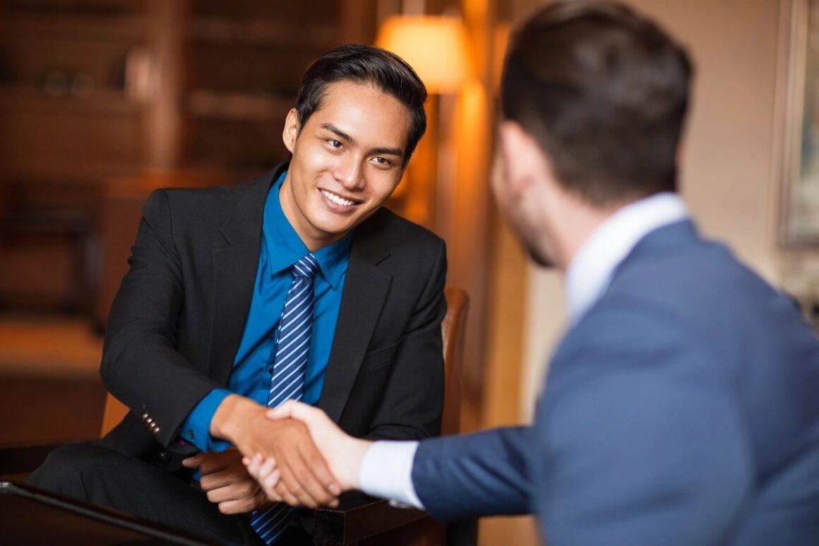 Two men shaking hands over a business deal.