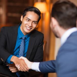 Two men shaking hands over a business deal.