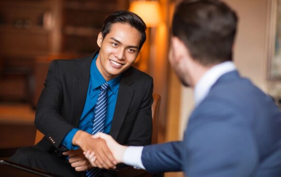 Two men shaking hands over a business deal.