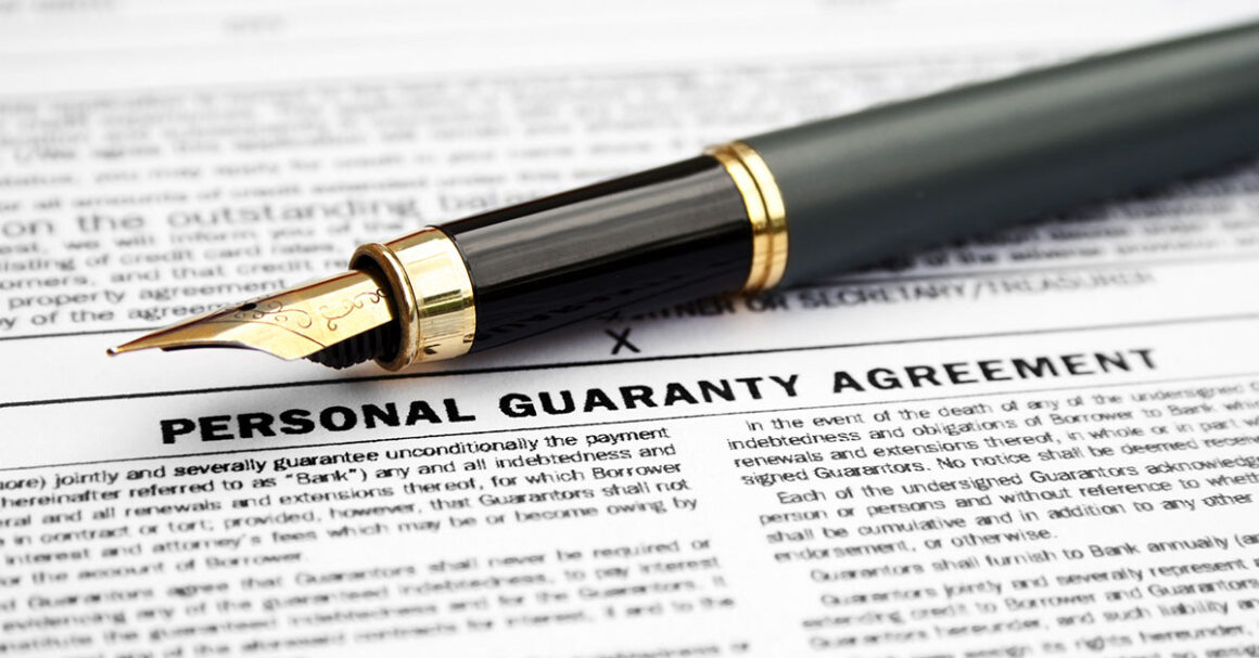 Pen laying on an agreement for a personal guaranty.