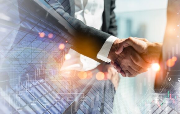 Capital Source: Strategic Funding Partnerships for Small Businesses Business professionals shaking hands in front of modern financial data overlay, representing strategic partnerships and growth funding.