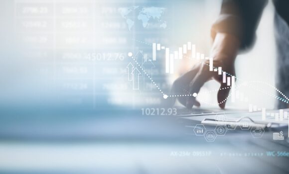 Hands of a professional reviewing financial reports with overlaid graphs and stock data visuals, symbolizing expert inventory financing strategy