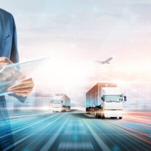 Businessman managing freight logistics with digital tablet, semi-trucks, and cargo containers