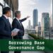 Two finance professionals reviewing combined utilization risk on a corporate terrace overlooking a financial district